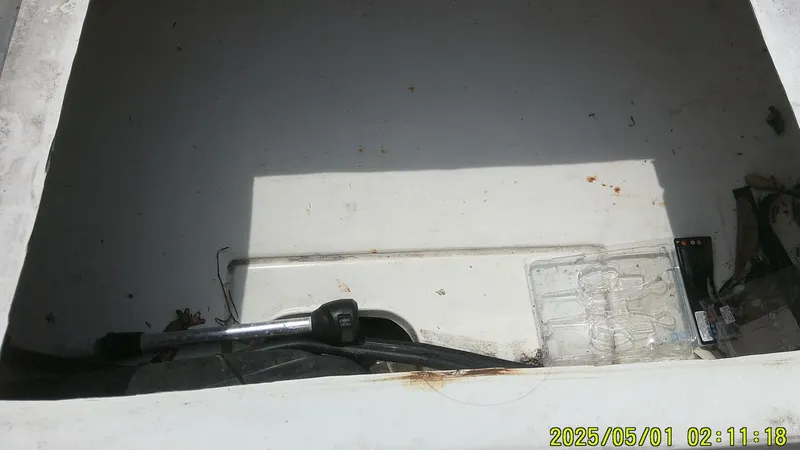 Slide: The Image of Empty storage compartment in a 2023 Mako 18 LTS boat. - 3
