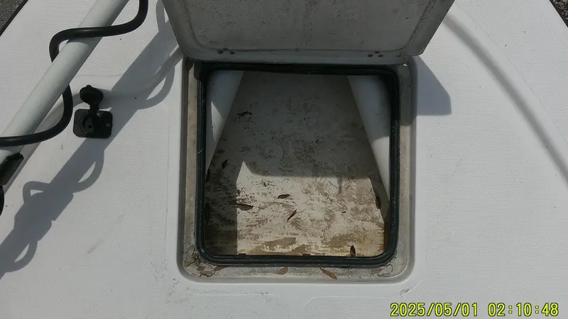 Slide: The Image of Open hatch on 2023 Mako 18 LTS boat, showing interior storage space. - 30