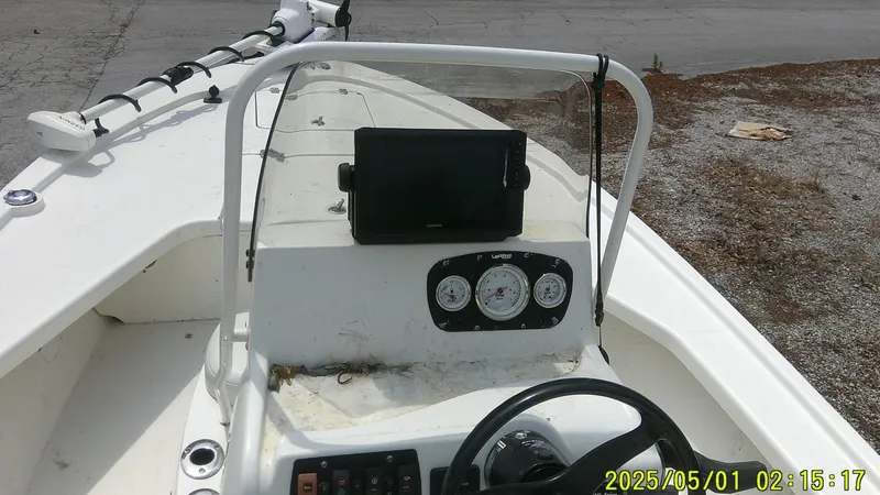 Slide: The Image of 2023 Mako 18 LTS boat dashboard with steering wheel and gauges. - 6