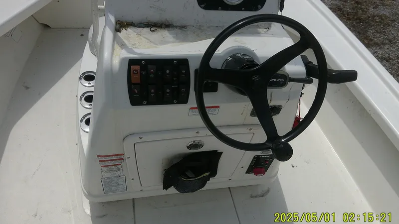 Slide: The Image of 2023 Mako 18 LTS boat console with steering wheel and control panel. - 7