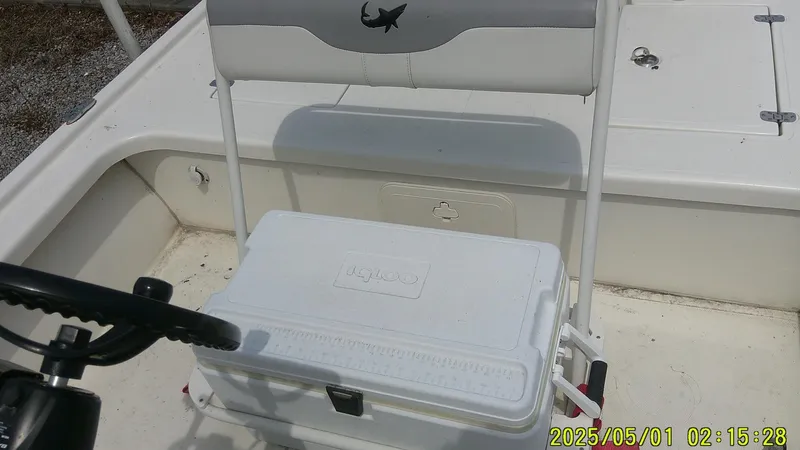 Slide: The Image of 2023 Mako 18 LTS boat interior with cooler and seating. - 8