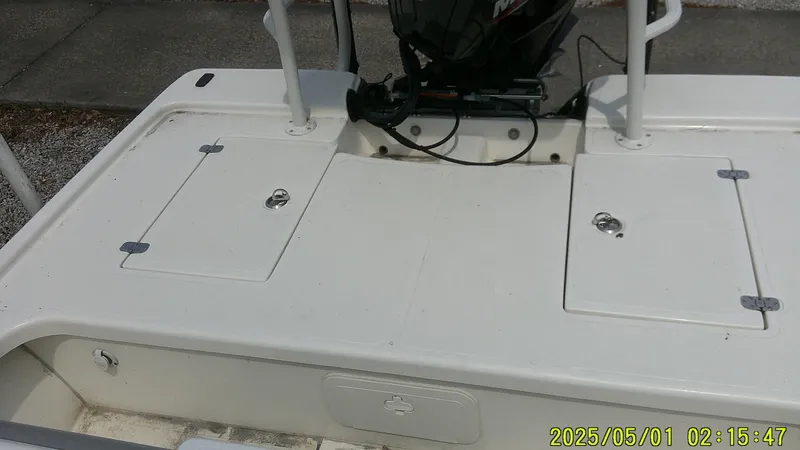 Slide: The Image of 2023 Mako 18 LTS boat deck with storage compartments and motor. - 9