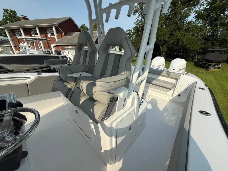 Slide: The Image of 2025 Cape Horn 32 XS boat with dual seats and modern design, parked outdoors. - 12