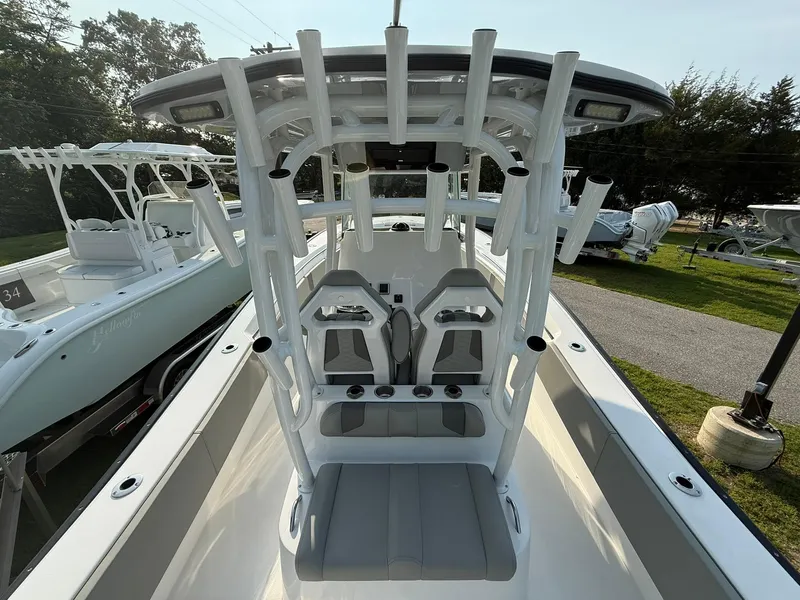 Slide: The Image of 2025 Cape Horn 32 XS boat interior with seating and console, docked outdoors. - 20