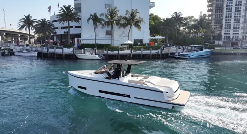 The Image of 2025 De Antonio Yachts D36 cruising in a scenic waterfront setting. - 0