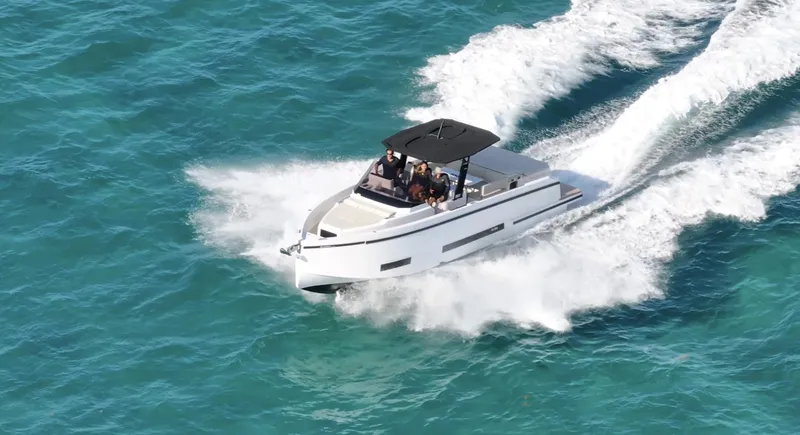 Slide: The Image of 2025 De Antonio Yachts D36 cruising on turquoise waters, showcasing sleek design and performance. - 1