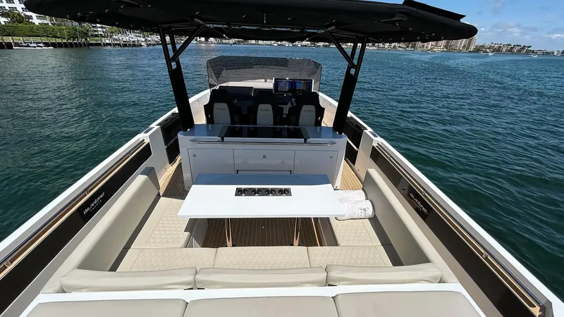 Slide: The Image of 2025 De Antonio Yachts D36 luxury boat interior with seating and table on open water. - 10