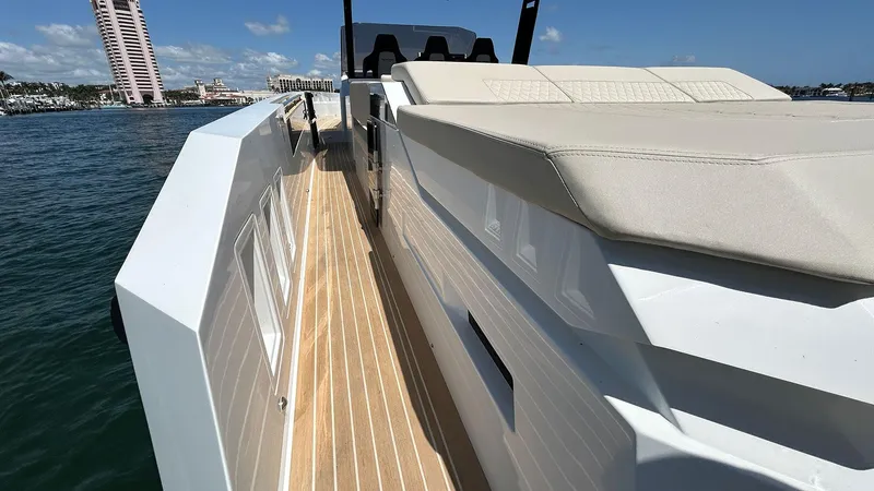 Slide: The Image of 2025 De Antonio Yachts D36 with sleek deck design and luxurious seating on open water. - 14