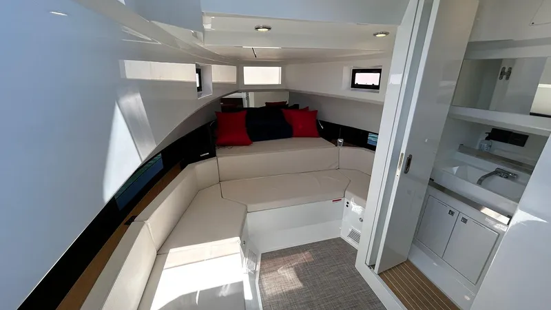 Slide: The Image of Interior of 2025 De Antonio Yachts D36, featuring modern seating and compact kitchenette. - 17