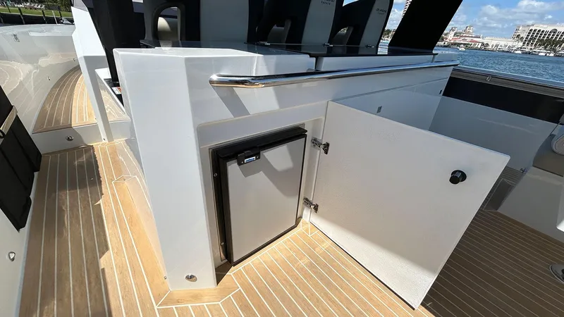 Slide: The Image of 2025 De Antonio Yachts D36 interior with open cabinet and mini fridge on deck. - 21