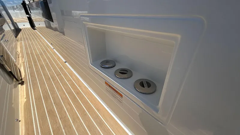 Slide: The Image of 2025 De Antonio Yachts D36 deck with fuel cap compartment, showcasing sleek design. - 23