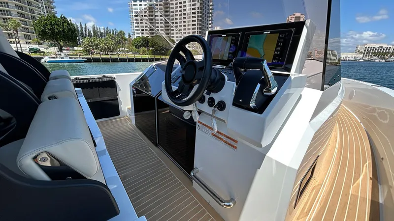 Slide: The Image of 2025 De Antonio Yachts D36 helm with modern controls and waterfront view. - 7