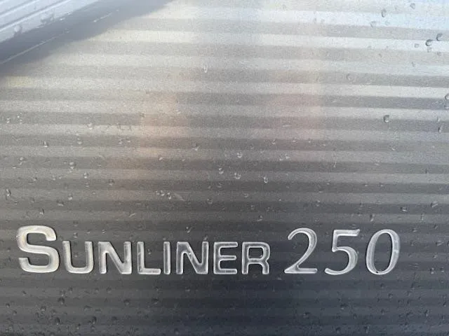 Slide: The Image of 2021 Harris Sunliner 250 logo on metallic surface with water droplets. - 12