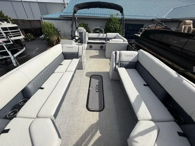 Slide: The Image of 2021 Harris Sunliner 250 pontoon boat with spacious seating and modern design. - 6