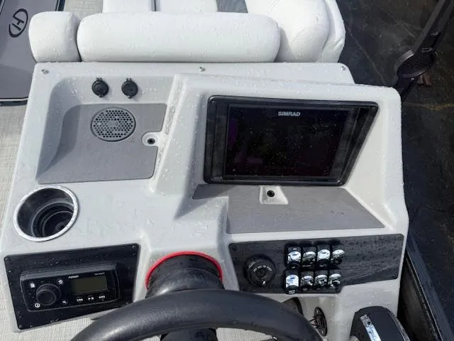 Slide: The Image of 2021 Harris Sunliner 250 dashboard with Simrad display and control panel. - 7