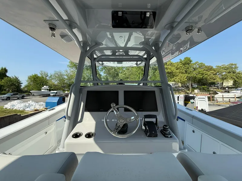 Slide: The Image of 2025 Yellowfin 39 Offshore boat cockpit with modern controls and dual screens. - 13