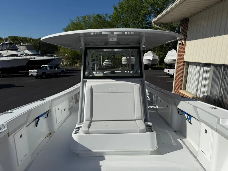 Slide: The Image of 2025 Yellowfin 39 Offshore boat with spacious deck and seating, docked outdoors. - 5