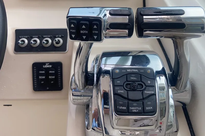Slide: The Image of Control panel of a 2013 Boston Whaler 270 Vantage boat, featuring throttle and switches. - 13