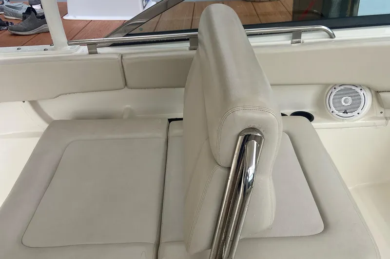 Slide: The Image of Boston Whaler 270 Vantage 2013 boat interior with beige seating and stainless steel accents. - 14
