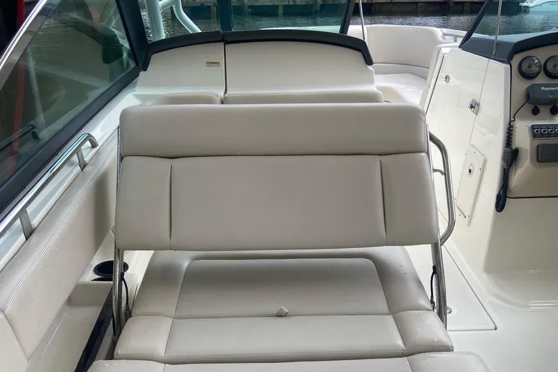 Slide: The Image of 2013 Boston Whaler 270 Vantage boat interior with white seating and control panel. - 15