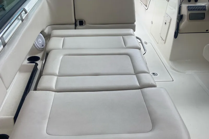 Slide: The Image of 2013 Boston Whaler 270 Vantage interior seating with cup holders and speaker. - 16