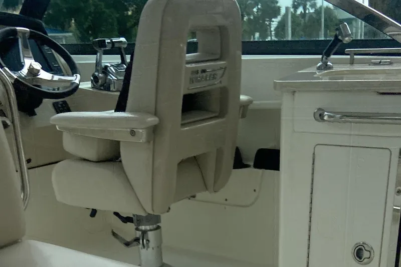 Slide: The Image of Interior of a 2013 Boston Whaler 270 Vantage boat, featuring helm and seating area. - 19