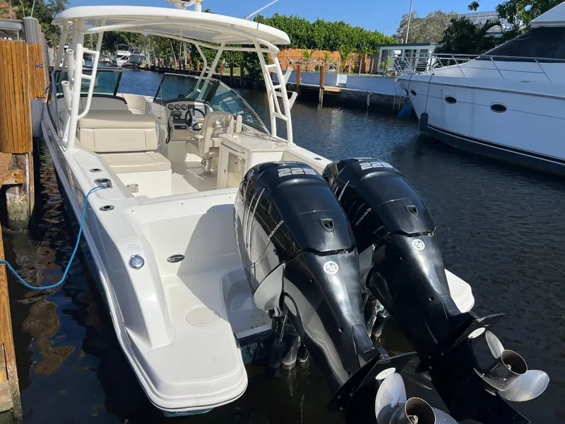 Slide: The Image of 2013 Boston Whaler 270 Vantage boat with dual engines docked in marina. - 20