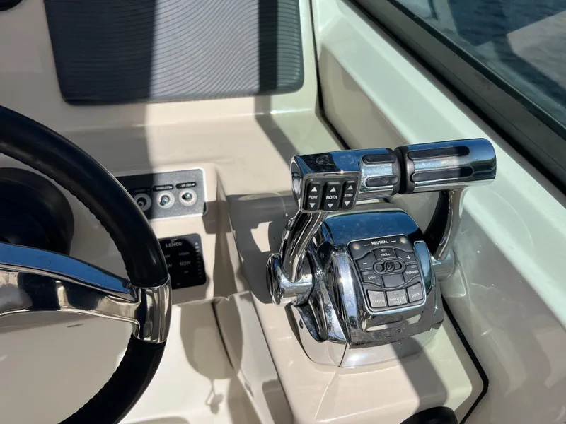 Slide: The Image of Control panel of 2013 Boston Whaler 270 Vantage boat with steering wheel and throttle levers. - 21