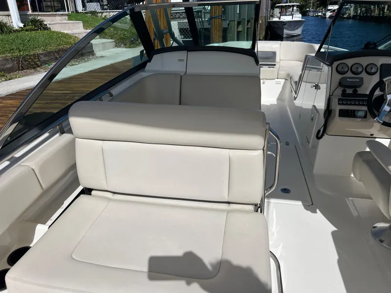 Slide: The Image of 2013 Boston Whaler 270 Vantage boat interior with beige seating and control panel. - 26
