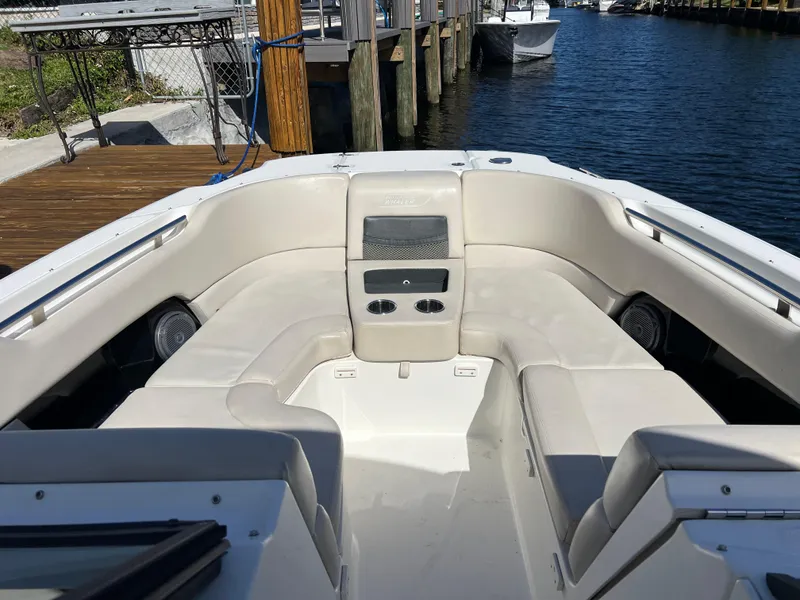 Slide: The Image of 2013 Boston Whaler 270 Vantage boat interior with beige seating and cup holders. - 30