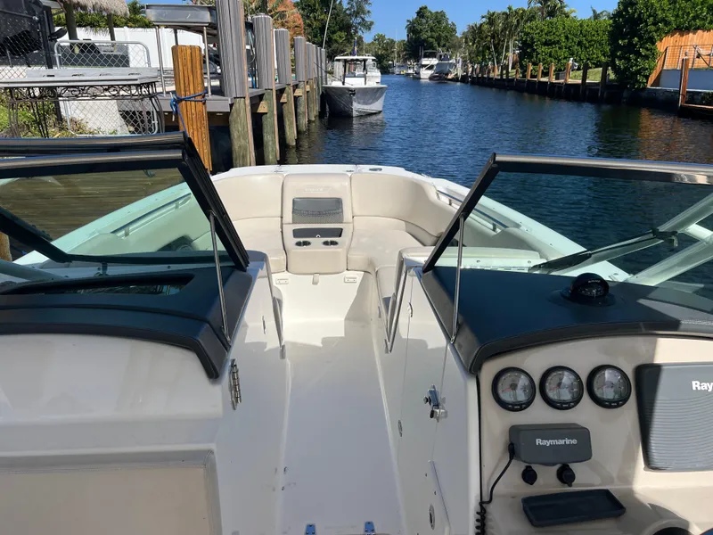 Slide: The Image of 2013 Boston Whaler 270 Vantage boat docked in a scenic canal setting. - 31