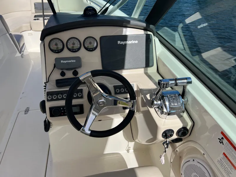 Slide: The Image of 2013 Boston Whaler 270 Vantage helm with Raymarine electronics and chrome steering wheel. - 32