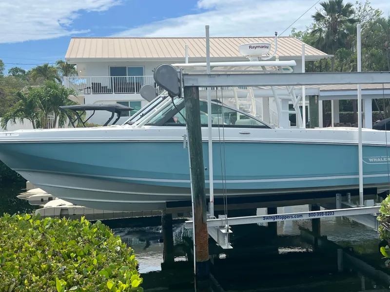 Slide: The Image of 2013 Boston Whaler 270 Vantage boat on lift near waterfront home. - 35