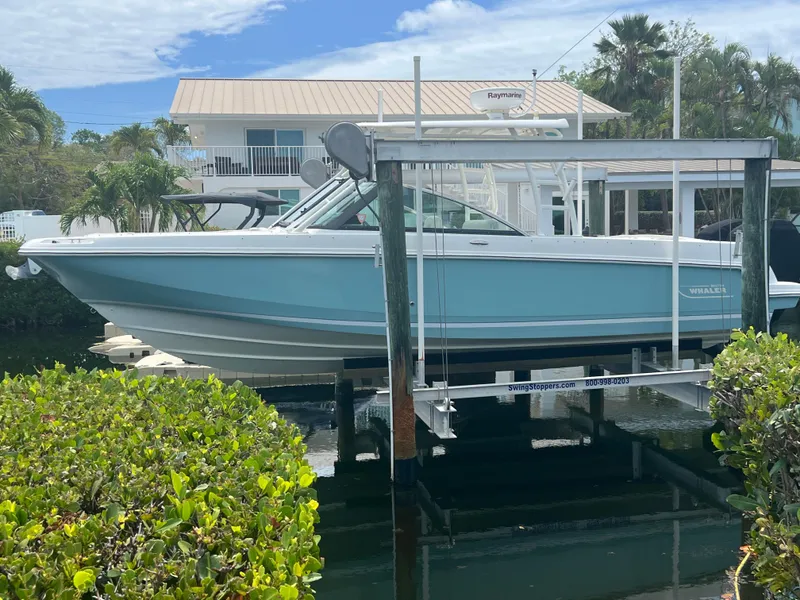 Slide: The Image of 2013 Boston Whaler 270 Vantage boat on lift, near waterfront home. - 36