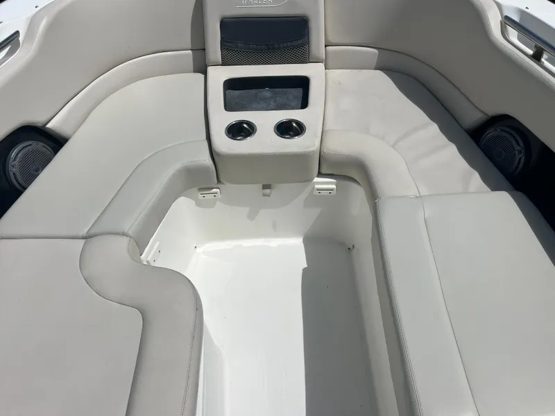 Slide: The Image of 2013 Boston Whaler 270 Vantage boat interior with cushioned seating and cup holders. - 39