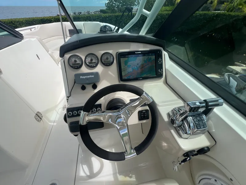 Slide: The Image of Steering console of 2013 Boston Whaler 270 Vantage with navigation display and controls. - 45