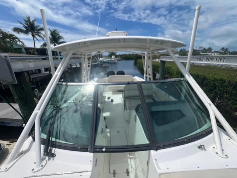 Slide: The Image of Boston Whaler 270 Vantage 2013 boat docked, featuring spacious deck and clear skies. - 46