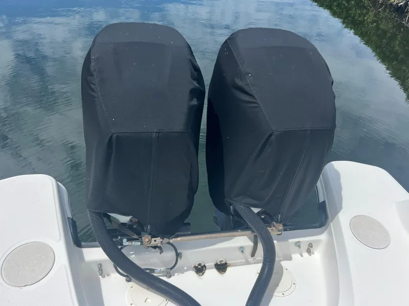 Slide: The Image of Twin covered engines on a 2013 Boston Whaler 270 Vantage boat. - 48