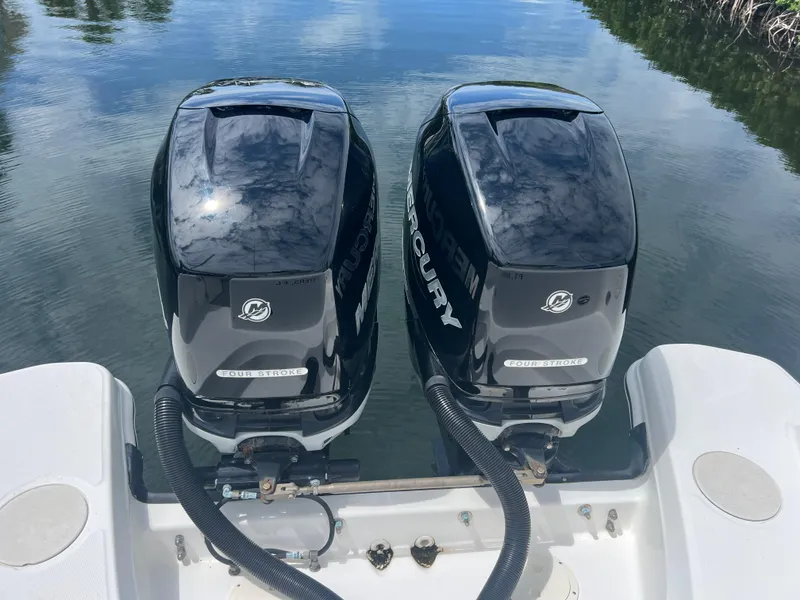 Slide: The Image of Twin Mercury outboard engines on a 2013 Boston Whaler 270 Vantage boat. - 49