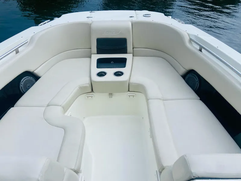 Slide: The Image of 2013 Boston Whaler 270 Vantage boat interior with white seating and cup holders. - 8