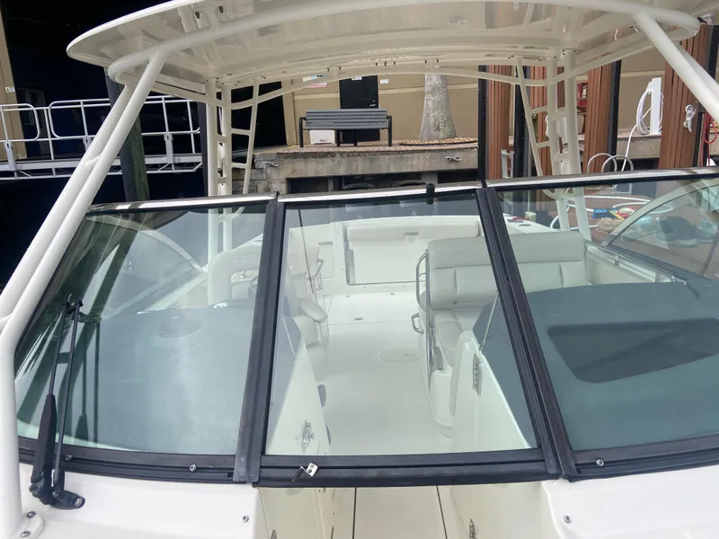 Slide: The Image of 2013 Boston Whaler 270 Vantage boat with spacious cockpit and windshield. - 9