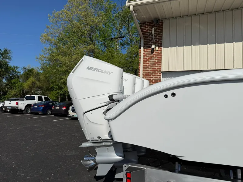 Slide: The Image of 2025 Yellowfin 39 Offshore boat with Mercury engines parked near a building. - 12