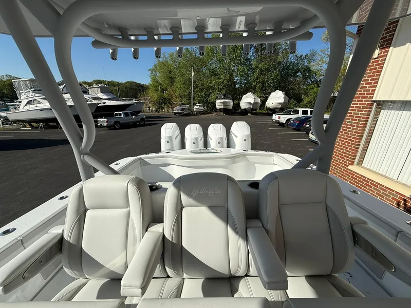 Slide: The Image of 2025 Yellowfin 39 Offshore boat with triple engines and luxurious seating in a marina setting. - 9