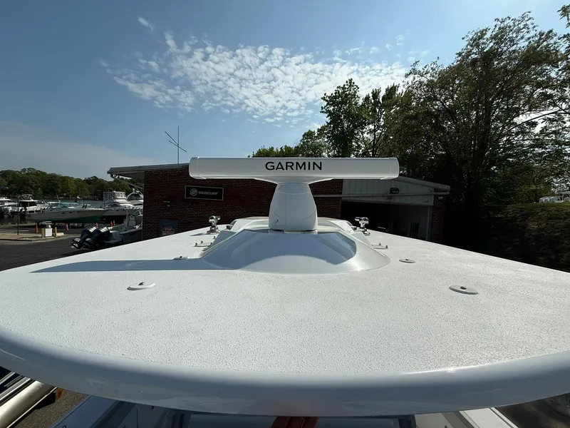 Slide: The Image of 2025 Yellowfin 39 Offshore boat with Garmin radar, docked under a clear sky. - 15