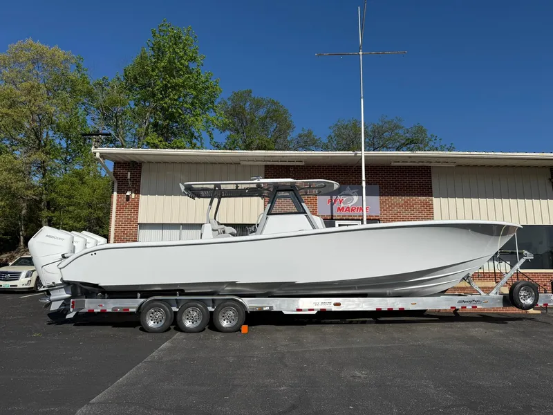 Slide: The Image of 2025 Yellowfin 39 Offshore boat on trailer, parked outside a building. - 2