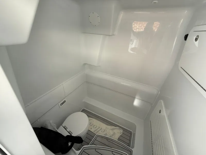 Slide: The Image of 2025 Yellowfin 39 Offshore boat interior cabin with toilet and storage. - 7