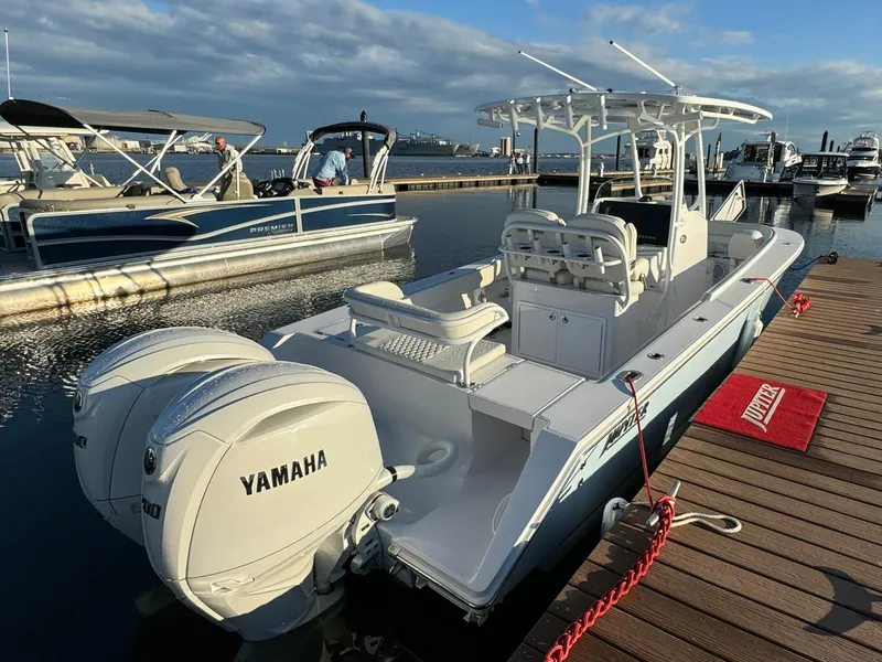 Slide: The Image of 2024 Jupiter 26 FS boat with Yamaha engines docked at marina. - 2