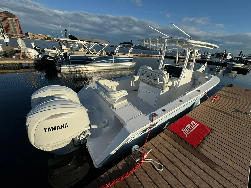 Slide: The Image of 2024 Jupiter 26 FS boat docked, featuring Yamaha engines, in a marina setting. - 3