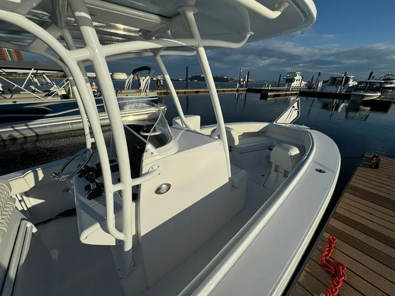 Slide: The Image of 2024 Jupiter 26 FS boat docked at marina, showcasing sleek design and spacious deck. - 5