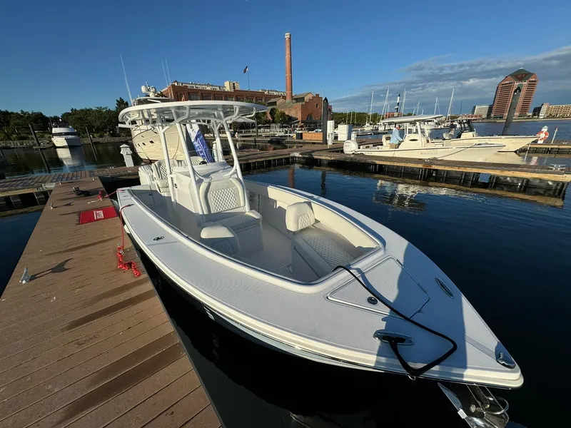 Slide: The Image of 2024 Jupiter 26 FS boat docked at marina under clear blue sky. - 0
